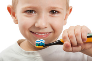 Little child with dental toothbrush brushing teeth